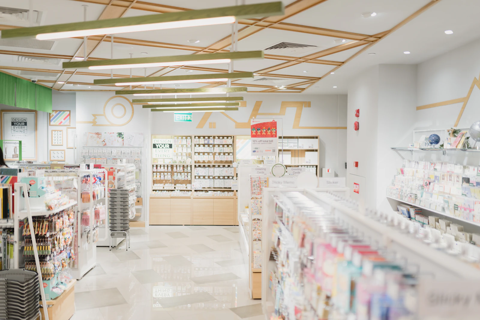 A bright pharmacy with shelves of products and a counter at the back.