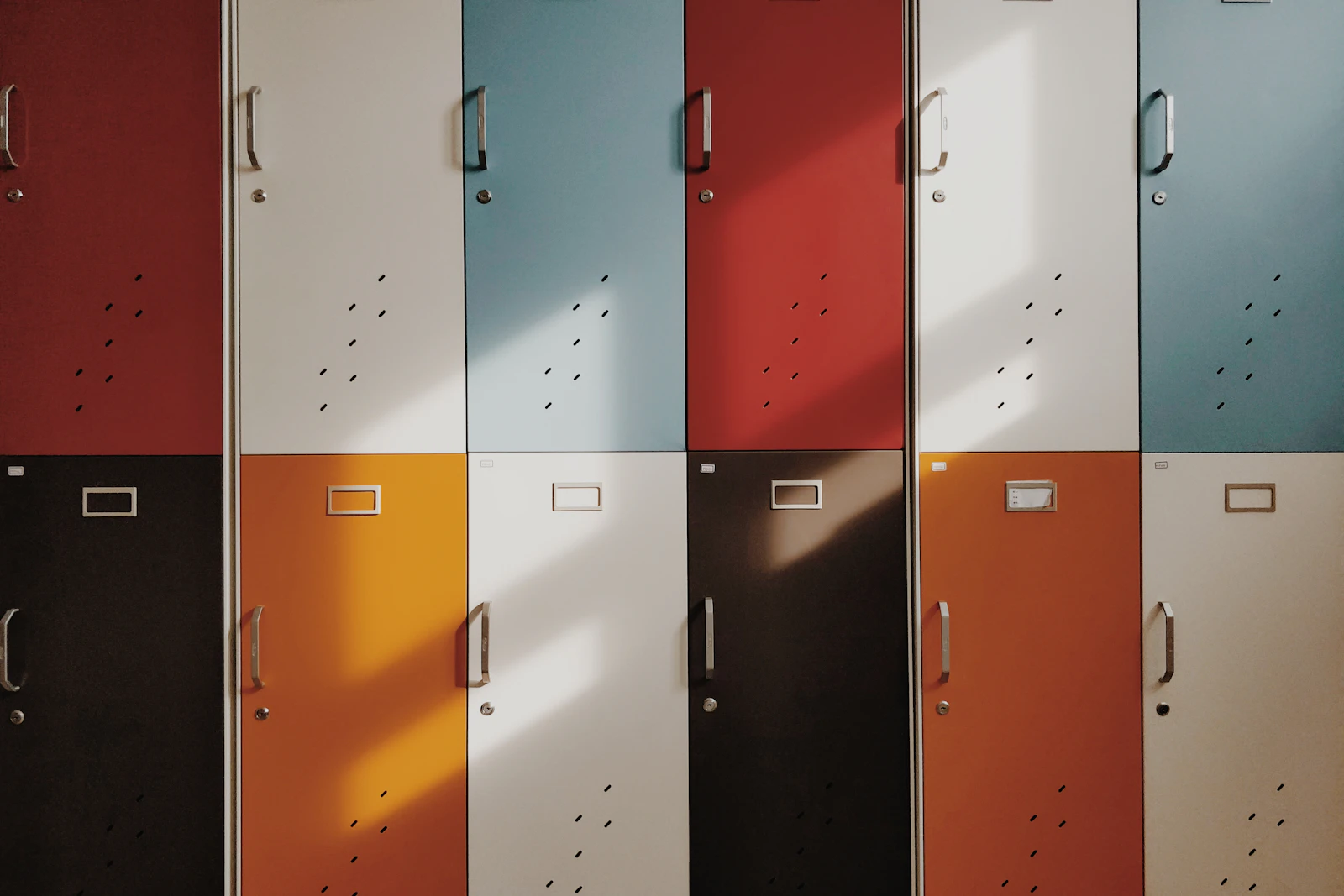 Rows of school lockers in red, cream, blue and orange.