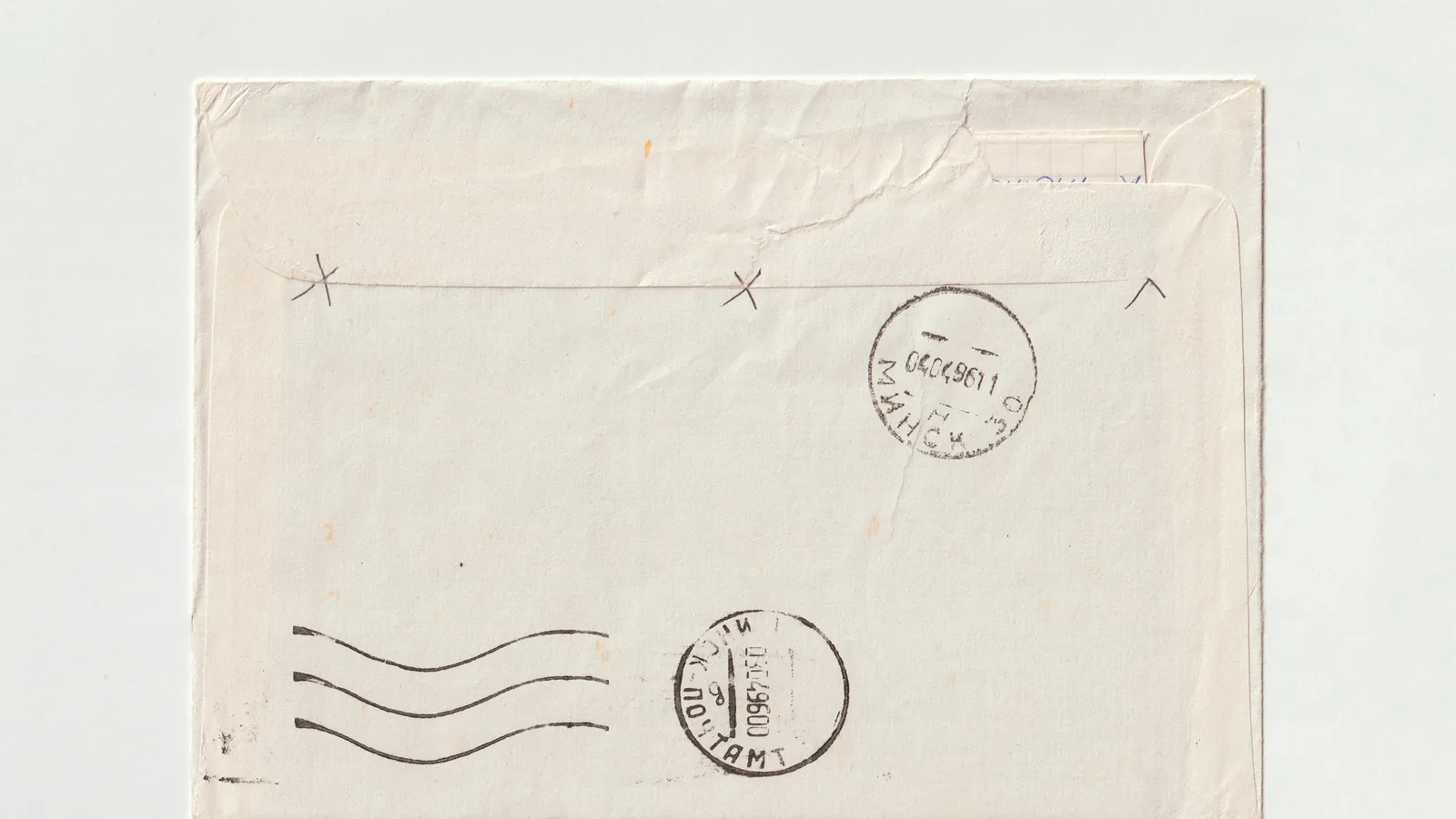 A plain envelope, franked and postmarked, on a pale ground.