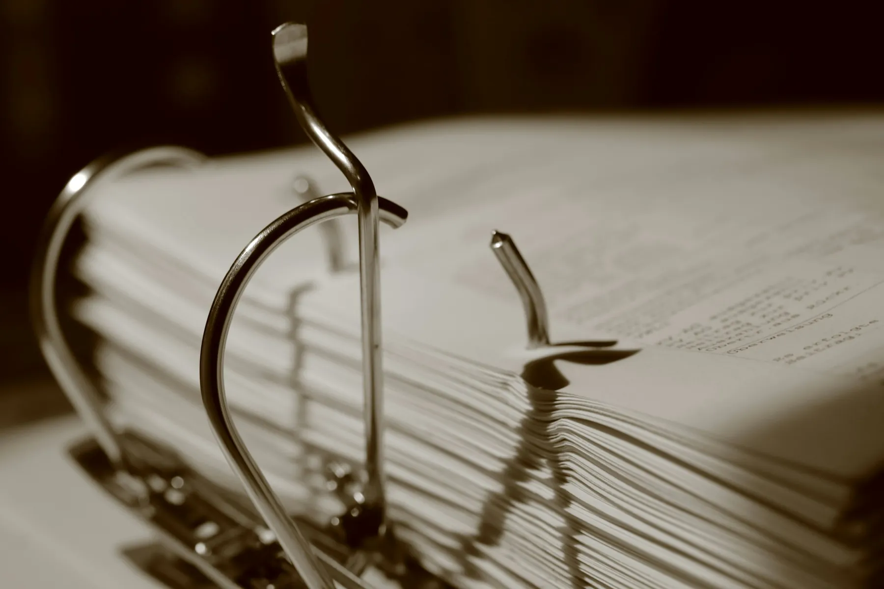 A thick binder of printed pages, the rings open, every sheet kept in order.